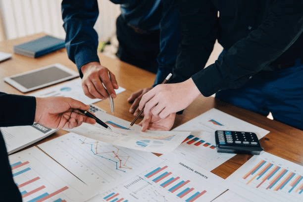 A sales team reviewing performance reports together